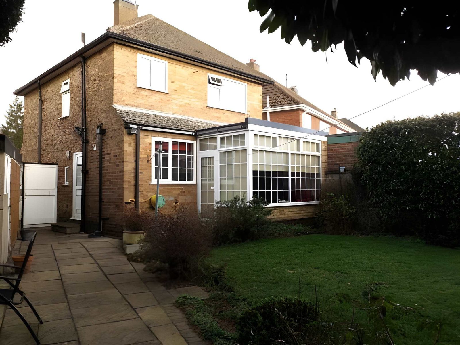 Rear of the house with conservatory, lawn and patio