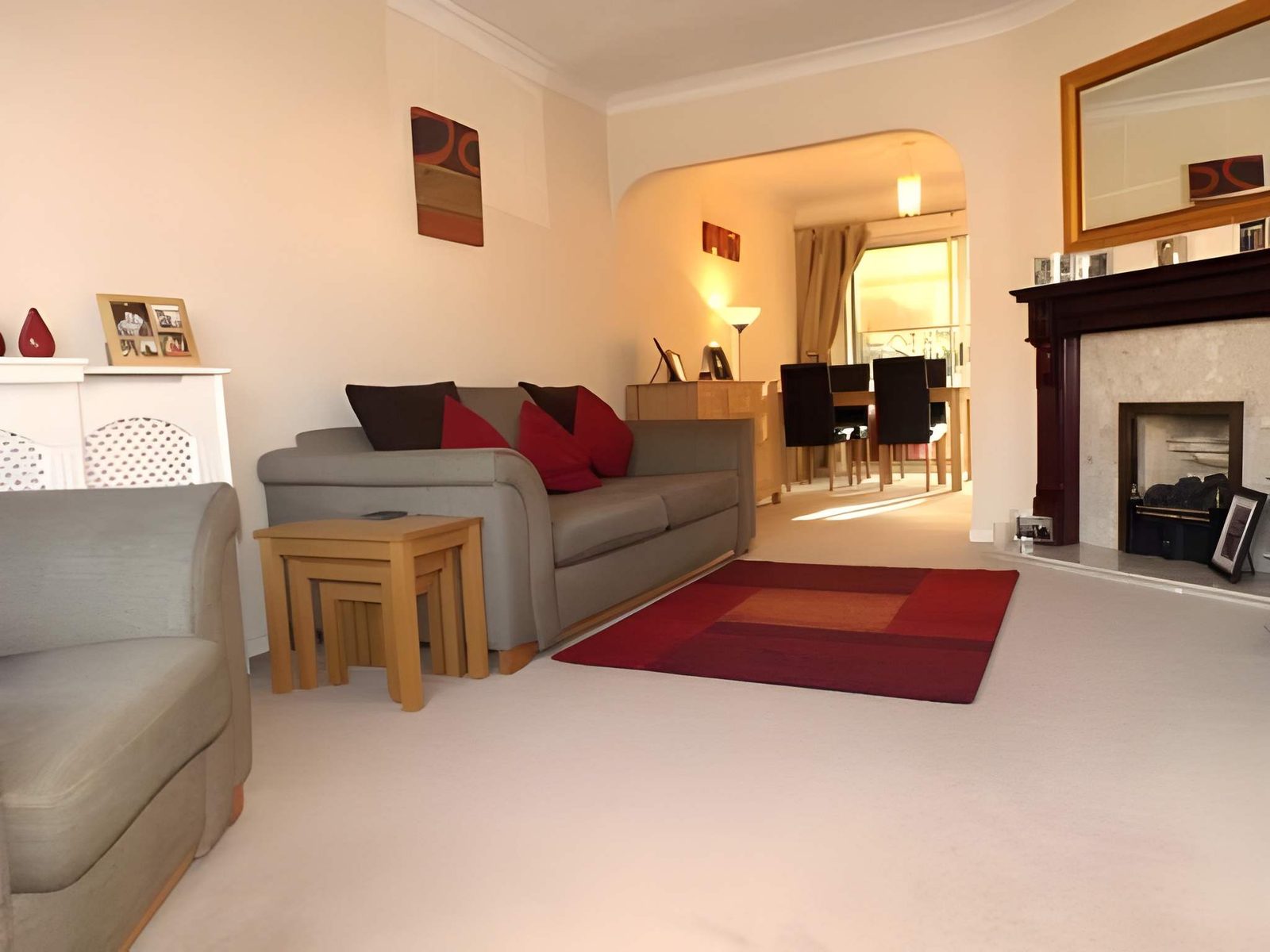 Lounge with fireplace and archway through to the dining room