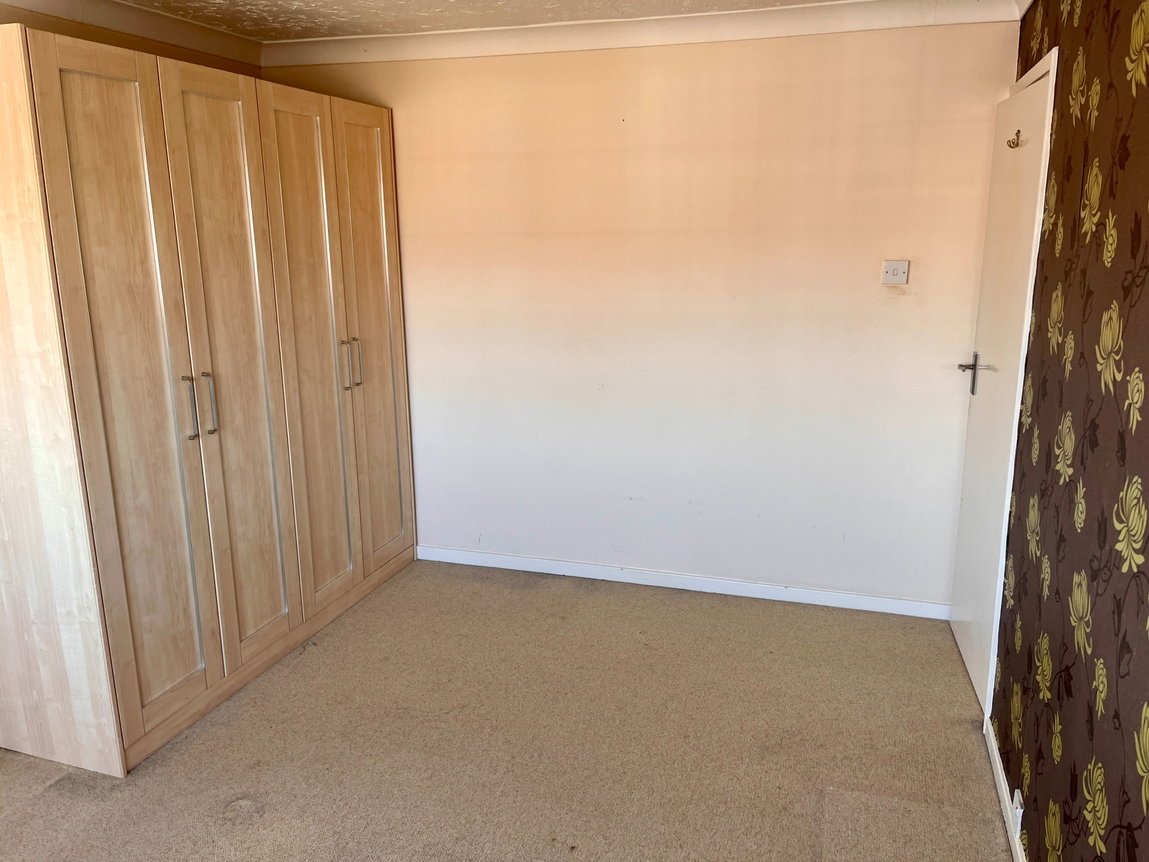 Bedroom 1 with freestanding wardrobe