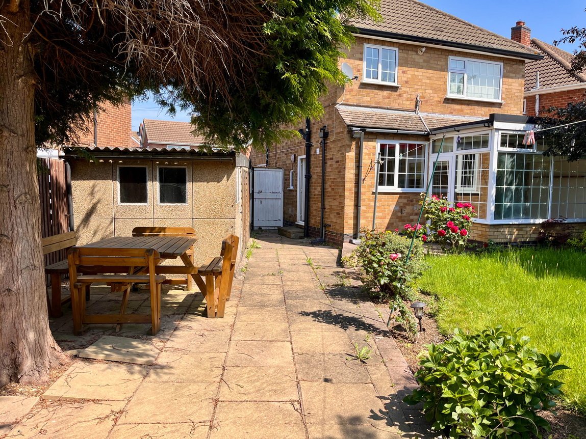 Rear garden with lawn, patio and conservatory
