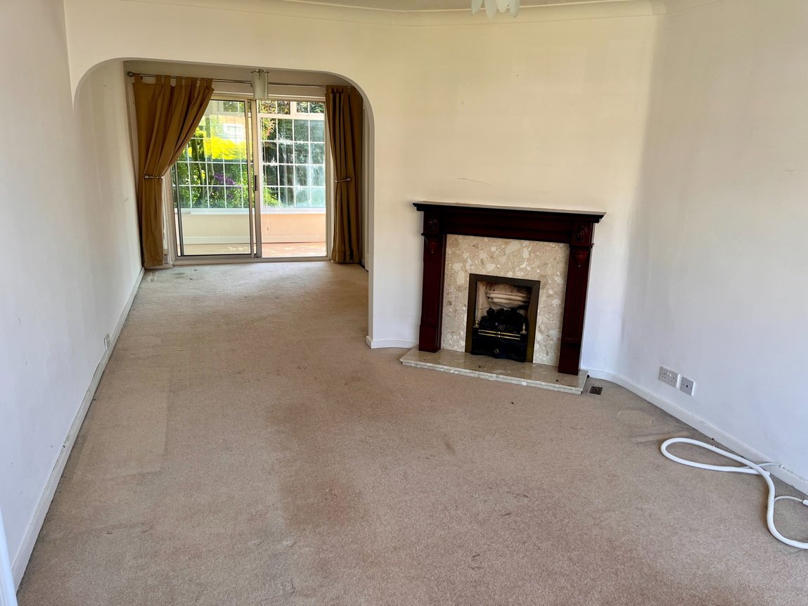 Lounge with fireplace and archway through to the dining room